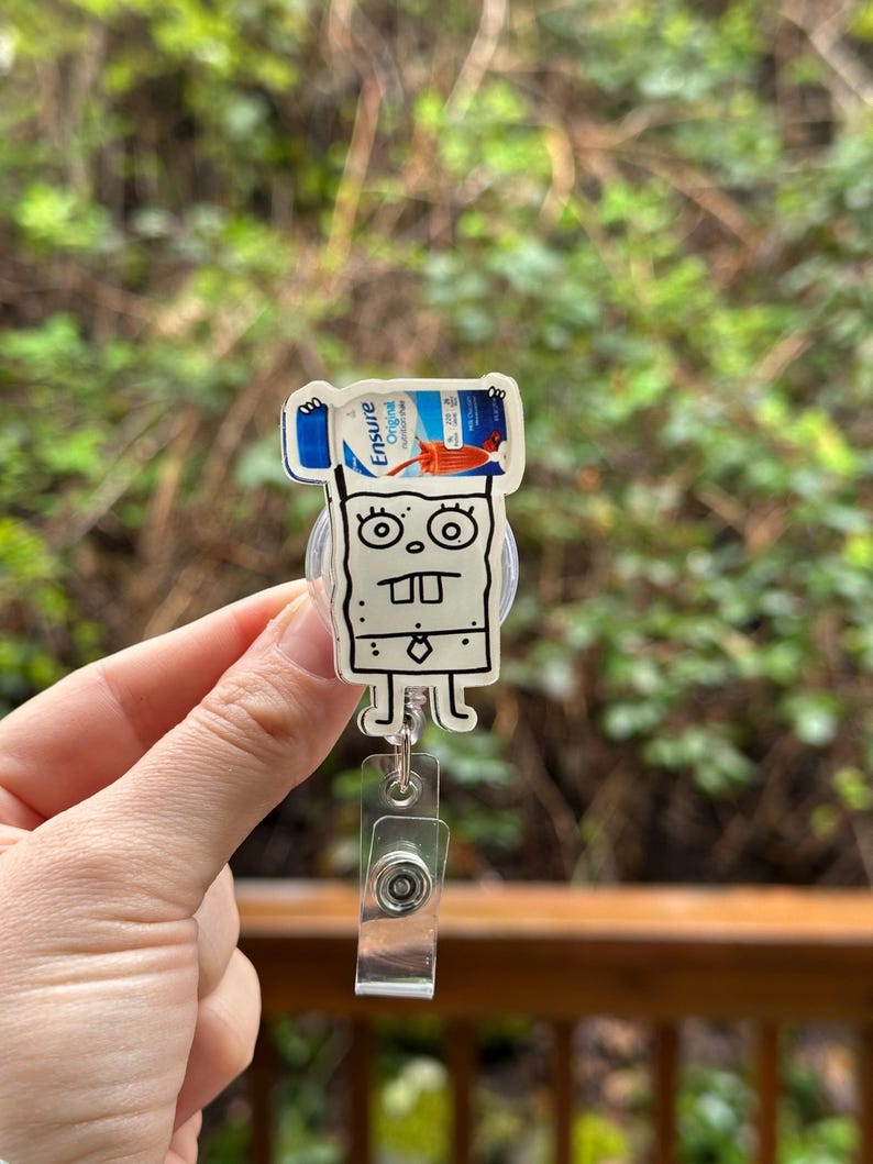 May include: A white cartoon character with a black outline holding a blue and white Ensure Original Nutrition Shake bottle. The character is wearing a black tie and has a white background.