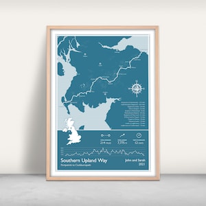 May include: A blue and white map of the Southern Upland Way in Scotland, showing the route from Portpatrick to Cockburnpath. The map includes the total distance, total ascent, and time to complete the trail. The text "John and Sarah 2021" is printed below the map.
