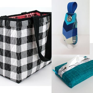 May include: Three quilted fabric bags: a black and white checked tote bag with black handles, a blue, white and teal chevron-patterned bag with a blue loop and button, and a teal tissue box cover with a white and grey stripe.