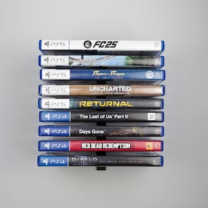 May include: A vertical wall-mounted black metal rack holding nine video game cases. The collection includes PS5 titles FC25, Horizon Forbidden West, Prince of Persia The Lost Crown, Uncharted Legacy of Thieves Collection, and Returnal, plus PS4 titles The Last of Us Part II, Days Gone, Red Dead Redemption II, and Diablo III Ultimate Evil Edition.