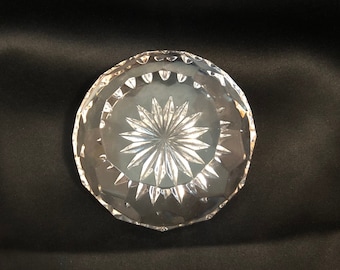 May include: A clear glass trinket dish with a starburst pattern.