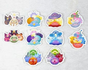 May include: A collection of colorful, die-cut stickers featuring various cartoon characters. The stickers showcase a variety of designs, including cats, creatures with hats, and other whimsical figures. Each sticker has a white border.