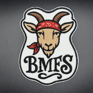 May include: Embroidered patch with a goat head wearing a red bandana. The goat is tan with brown horns and ears. The patch has the letters "BMFS" in black, stylized font, and a white border.