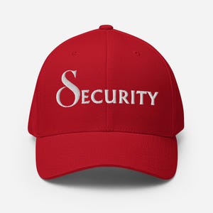 May include: A bright red baseball cap featuring the word SECURITY embroidered in white capital letters across the front panel. The cap has a structured crown, a curved brim, and a button at the top center, showcasing a clean and simple design.
