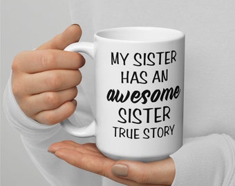 May include: White ceramic mug with black text that reads "My sister has an awesome sister true story".