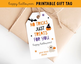 May include: A white Halloween gift tag with the text "NO TRICKS JUST TREATS FOR YOU" in orange and purple. The tag features a bat, pumpkin, ghost, and stars. The tag is tied to a wrapped package with twine.