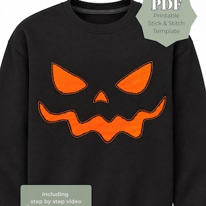 May include: A black sweatshirt featuring a large orange jack-o'-lantern face graphic on the front. A light green badge in the top right corner reads PDF Printable Stick & Stitch Template, and a bottom left badge reads Including step by step video.