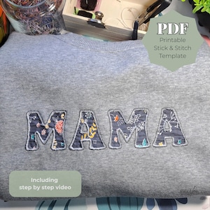 Puede incluir: Una sudadera gris con la palabra "MAMA" bordada en la parte delantera con letras estampadas florales. La sudadera también tiene el texto "PDF Printable Stick & Stitch Template" y "Including step by step video".