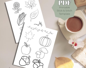 May include: Two white sheets with black line drawings of fall-themed elements, including a sunflower, corn, and pumpkin. The text "PDF Printable Stick & Stitch Template" is in a green hexagon. A cup of coffee and a leaf are also visible.