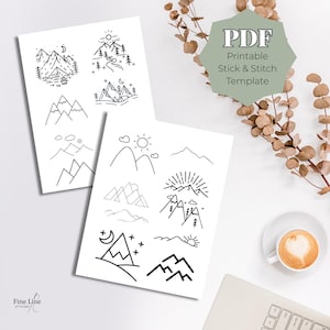 Op de afbeelding: Twee witte vellen met zwarte bergontwerpen. Eén vel heeft een berg met een tent, bomen en een maan. Het andere vel heeft een zon, wolken en bergen. De tekst "PDF Printable Stick & Stitch Template" is ook zichtbaar.