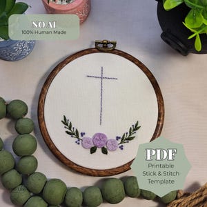 May include: A round embroidery hoop with a cross design. The cross is stitched in purple thread, with a floral wreath below. The text "NO AI 100% Human Made" is visible. The text "PDF Printable Stick & Stitch Template" is also visible.