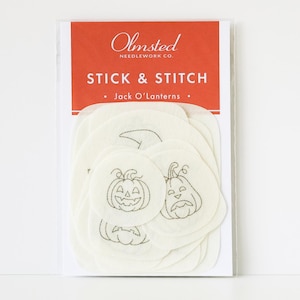 May include: A package of Olmsted Needlework Co. Stick & Stitch Jack O'Lanterns embroidery patterns. The packaging features a red header with white text and contains multiple off-white, circular adhesive fabric sheets with black line art.