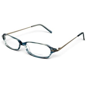 Op de afbeelding: Bril met een ovaal montuur in een blauw en grijs gemarmerd patroon en dunne metalen pootjes. De merknaam STEFANEL staat op het rechterglas gedrukt en is in de poot gegraveerd. De uiteinden van de pootjes zijn afgewerkt met donkere tips.