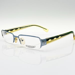 May include: A pair of blue and gold spectacles with a rectangular frame. The brand name "ECKERSON" is printed on the frame.