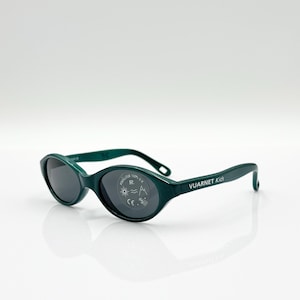 May include: Dark green sunglasses with oval lenses. The sunglasses have the text "VUARNET Kids" on the arm. The lenses are dark gray. The sunglasses are on a white surface.