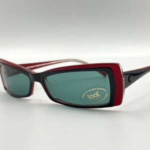 May include: Red and black sunglasses with a gold logo that says "Look Italy Quality Sunglasses UV Protection".