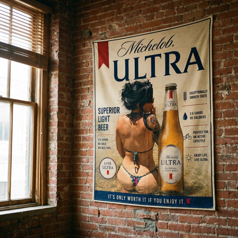 May include: A rectangular wall banner featuring a Michelob ULTRA advertisement. The design includes a beer bottle, text detailing 2.6 carbs and 95 calories, and a graphic of a person in a bikini. The text reads It's Only Worth It If You Enjoy It.