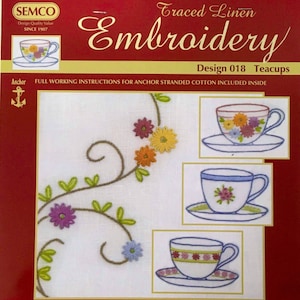 May include: Embroidery pattern for teacups, featuring a floral design with a vine and leaves. The pattern is on white fabric with a red border. The text "Traced Linen Embroidery Design 018 Teacups" is at the top of the image. The text "FULL WORKING INSTRUCTIONS FOR ANCHOR STRANDED COTTON INCLUDED INSIDE" is below the pattern.