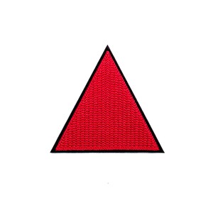 May include: A red triangle patch with a black outline.