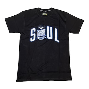 May include: Black t-shirt with a white graphic of the word "SOUL" in a blue outline. The graphic also includes a crest with a bird and the letters "ΦΒΣ" and "Founded 1911".