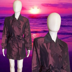 May include: A set of three ceramic mugs with a speckled, matte finish. The mugs are in shades of cream, light gray, and dark gray. Each mug has a simple, minimalist design and a rounded handle.