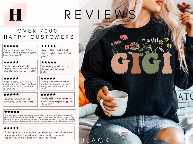 May include: Black sweatshirt with a floral design and the word "GIGI" in a retro font. The sweatshirt is being modeled by a person holding a white mug. The text "OVER 7000 HAPPY CUSTOMERS" and several five-star reviews are visible in the background.