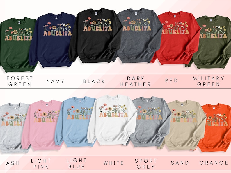 May include: A collection of sweatshirts in various colors featuring the text "Abuelita" with a floral design. The colors include forest green, navy, black, dark heather, red, military green, ash, light pink, light blue, white, sport grey, sand, and orange.