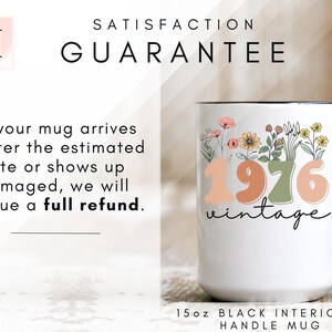 The image is a promotional advertisement for a mug, featuring a white mug with a floral design and text that reads "1976 Vintage". The mug is placed on a wooden surface, and there is text above and below the mug that provides information about the guarantee.