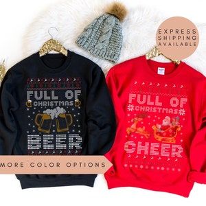 May include: Two Christmas sweaters, one black with a beer mug design and the text "Full of Christmas Beer", and one red with a reindeer and sleigh design and the text "Full of Christmas Cheer".