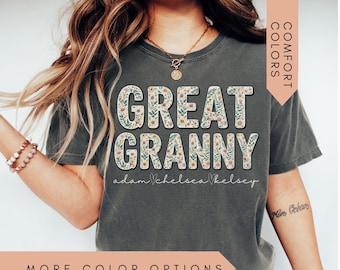 Può includere: T-shirt grigio scuro con la scritta "GREAT GRANNY" in grandi lettere floreali. Sotto il testo i nomi "adam, chelsea, kelsey". La maglietta ha maniche corte e una vestibilità comoda.