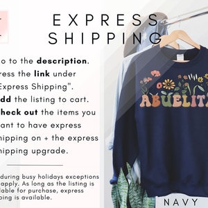 May include: Navy blue sweatshirt with the text "Abuelita" in rainbow colors with floral accents. The text "Express Shipping" is written in black text on a white background.