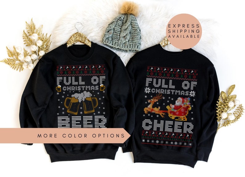 May include: Two black Christmas sweaters with a festive design. One sweater features a beer mug with the text "Full of Christmas Beer". The other sweater features a Santa Claus riding in a sleigh with reindeer and the text "Full of Christmas Cheer".