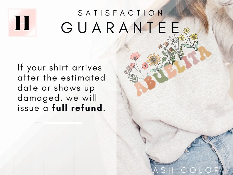 May include: A light gray sweatshirt with the word "Abuelita" in colorful, retro-style letters. The letters are surrounded by a floral design with pink, yellow, and green flowers. The text "Satisfaction Guarantee" is at the top of the image. The text "If your shirt arrives after the estimated date or shows up damaged, we will issue a full refund." is at the bottom of the image. The text "ASH COLOR" is at the bottom right of the image.