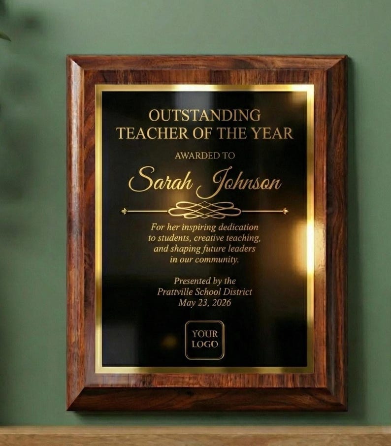 Personalized wooden award plaque with black engraved plate and gold border — Outstanding Teacher of the Year example with customizable recipient name, message, date, and logo.