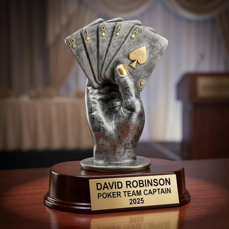 Close-up of laser-engraved gold nameplate on personalized poker trophy showing custom name, achievement, and year