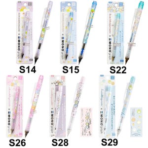 May include: A collection of six Sumikkogurashi x MONO graph mechanical pencils in various pastel colours, each packaged with a branded backing card. The pencils feature character prints, clear clips, and 0.5mm lead mechanisms, labelled S14 through S29.