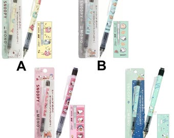 May include: Four Snoopy-themed mechanical pencils with matching packaging and small cards. Each pencil features a different design, including Snoopy characters and patterns. The pencils are 0.5 mm and come in various colors.
