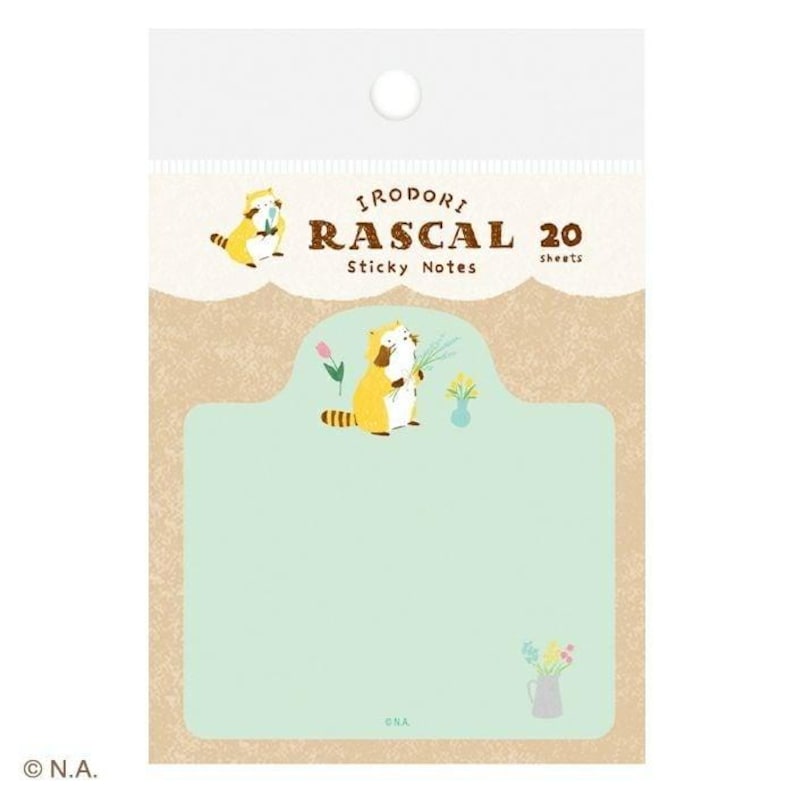 May include: A package of Irodori Rascal sticky notes. The package features a tan background with a light green label. The label has a cartoon raccoon holding flowers. The text "Irodori Rascal Sticky Notes 20 sheets" is printed on the package.