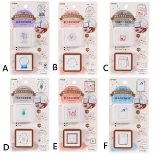 Op de afbeelding: Een verzameling van zes Hancoco Layer Stamps, elk met een uniek ontwerp. De stempels tonen illustraties van een sneeuwbol, wolk, lunchtas, cocktail, bloemen en een notitieboek. Elke stempel is verpakt op een witte kaart met Japanse tekst.