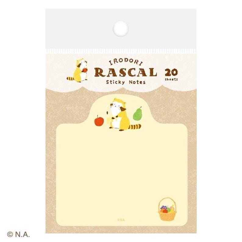 May include: A package of "Irodori Rascal" sticky notes. The design features a cartoon raccoon with a chef's hat, an apple, and a pear. The notes are yellow with a brown border and a basket of fruit.