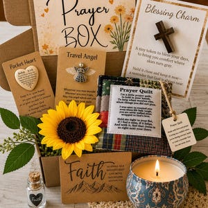 May include: A prayer box gift set containing a wooden cross on a card, a pocket heart, a metal angel charm, a small prayer quilt, a glass vial with a faith label, a sunflower, and a lit candle in a blue patterned tin with various inspirational cards.