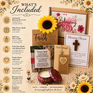 May include: A gift set with a variety of items, including a candle, a prayer quilt, a cross, and a travel angel. The set includes a decorative sunflower and a card with a heart. The items are arranged in a box with the words "Blessing Box".