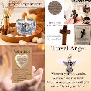 May include: A lit soy wax candle in a decorative tin with a floral design, displayed on a wooden tray with decorative stones. The image also includes a wooden cross, a pocket heart, and a travel angel charm.