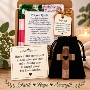 May include: A gift box containing a small quilted fabric square with a printed poem titled Prayer Quilt, a wooden cross with a heart cutout in a black drawstring pouch, and two additional cards with printed text about prayer and blessings.