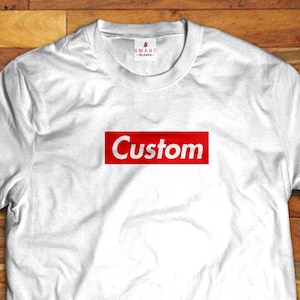 May include: White t-shirt with a red box that says "Custom" on it.