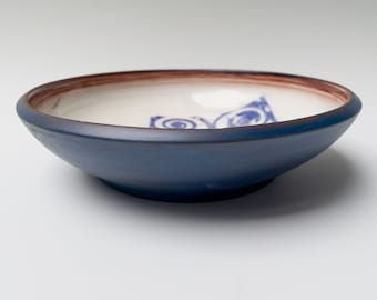 Blue ceramic bowl with abstract design, handmade pottery