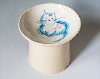 Raised cat feeder on a pedestal with blue cat, elevated ceramic cat bowl