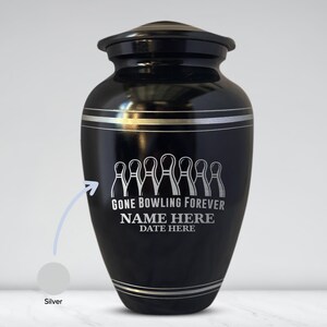 May include: A black urn with silver trim and a lid. The urn features the text "GONE BOWLING FOREVER" above a row of bowling pins. Below the text are the words "NAME HERE" and "DATE HERE".
