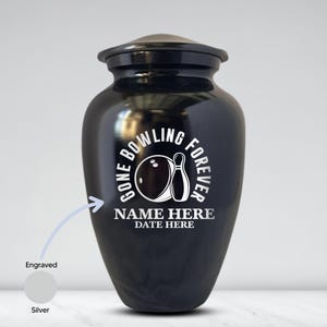 May include: Black urn with a lid, featuring the text "GONE BOWLING FOREVER" around a bowling ball and pin graphic. The bottom of the urn has space for a name and date. The urn is engraved and silver.