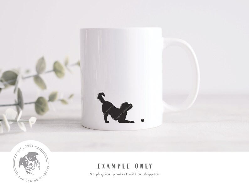 May include: White ceramic mug with a black silhouette of a dog playing fetch. The dog is facing right and has its tail wagging. The mug has a black ball on the bottom right corner.